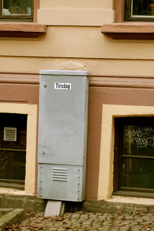 this is an image of a small box next to a building