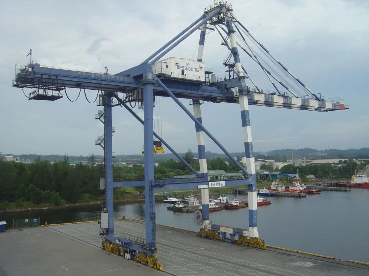 there is a very large crane on top of a boat dock