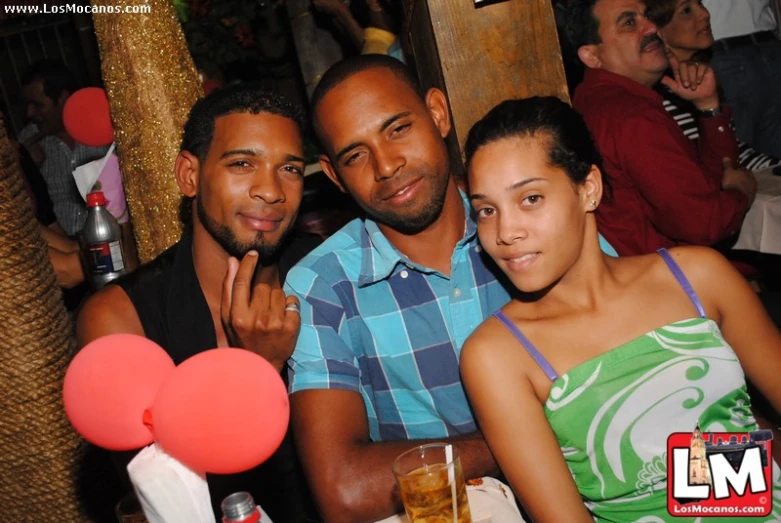 a couple of people posing for a picture at a party