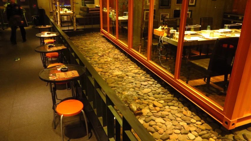 a restaurant with tables, chairs, and mirrors in it