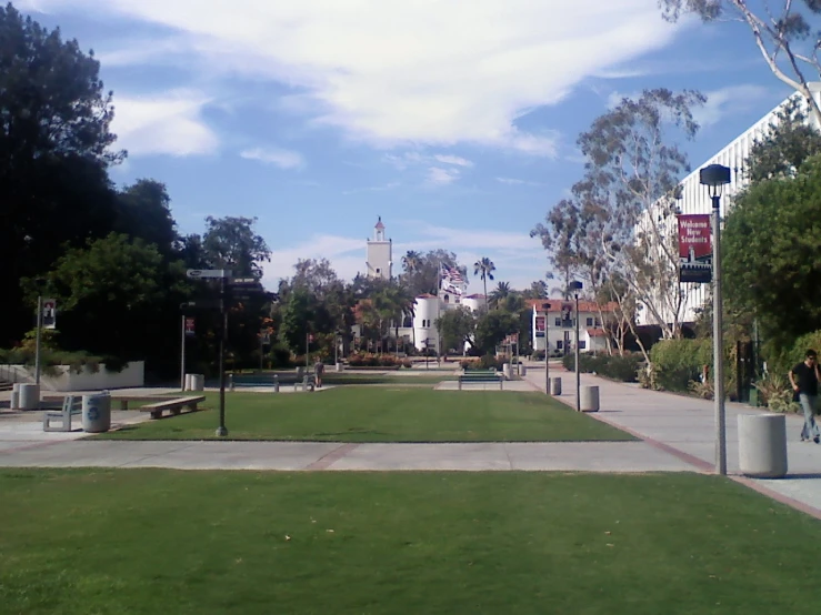 a park is shown with benches and lots of grass