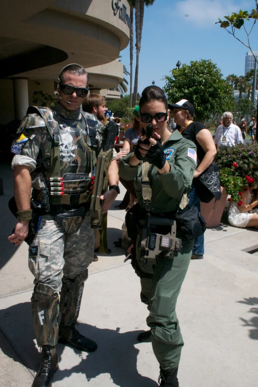 a man and woman dressed in army gear walking