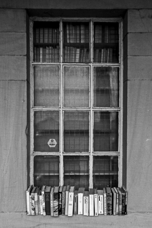 a window covered in books, with an arrow sign