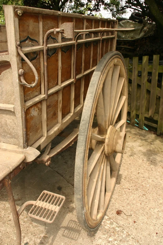there is a old wagon being used as a wheel barrow