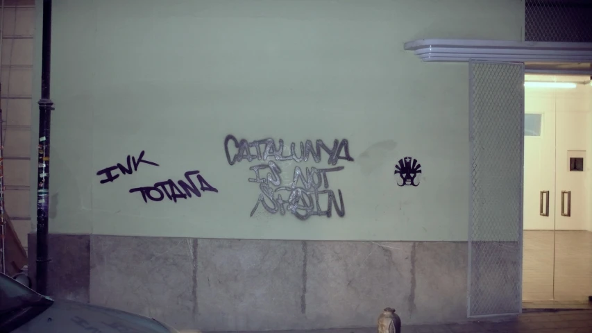 a wall with graffiti written on it in different languages