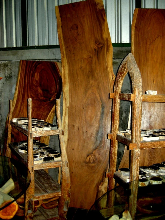 two wooden chairs made of logs and other wood pieces