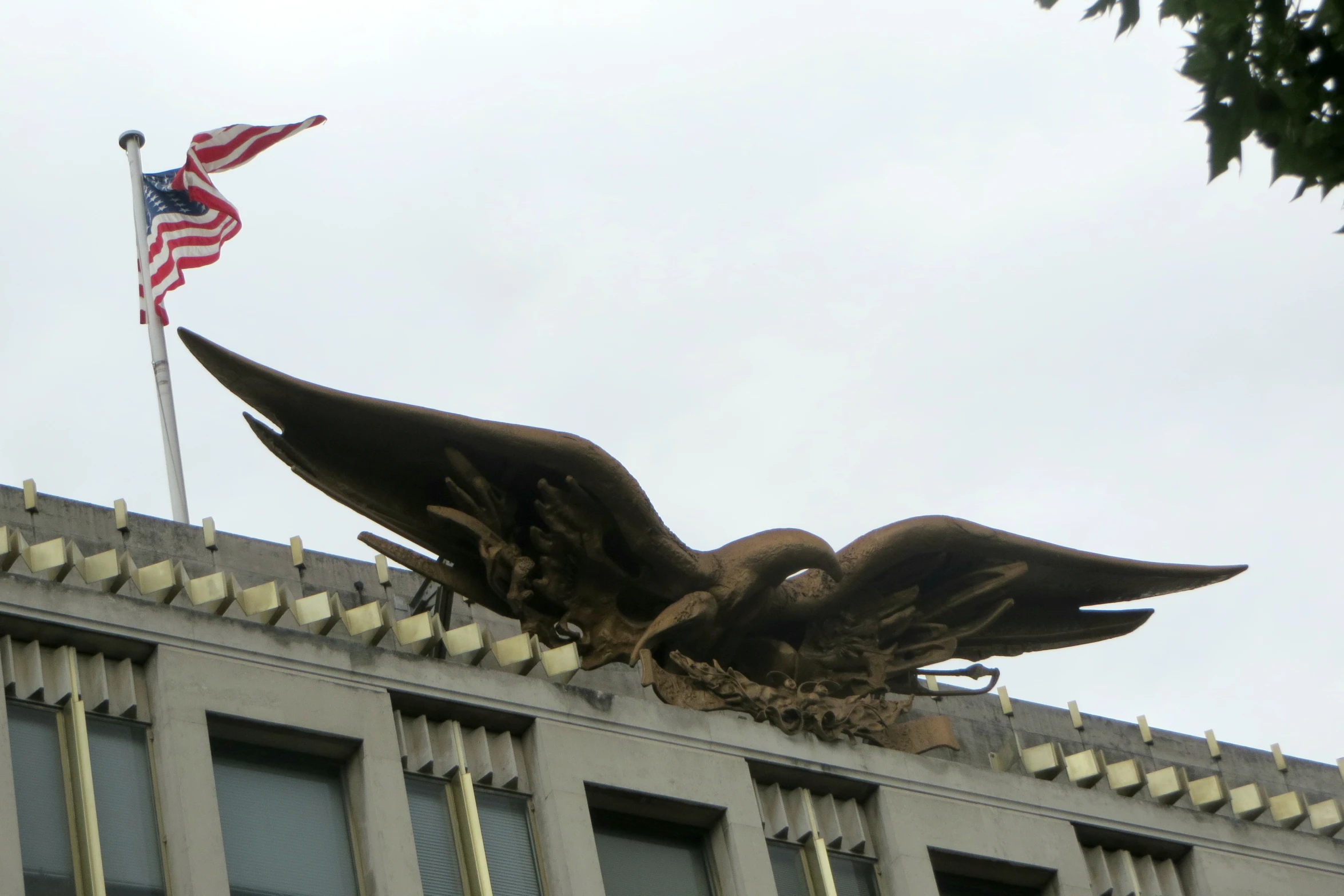 the eagle statue is perched on top of the building