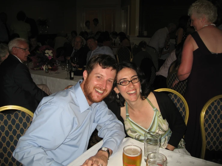 two people posing for a po at a formal function