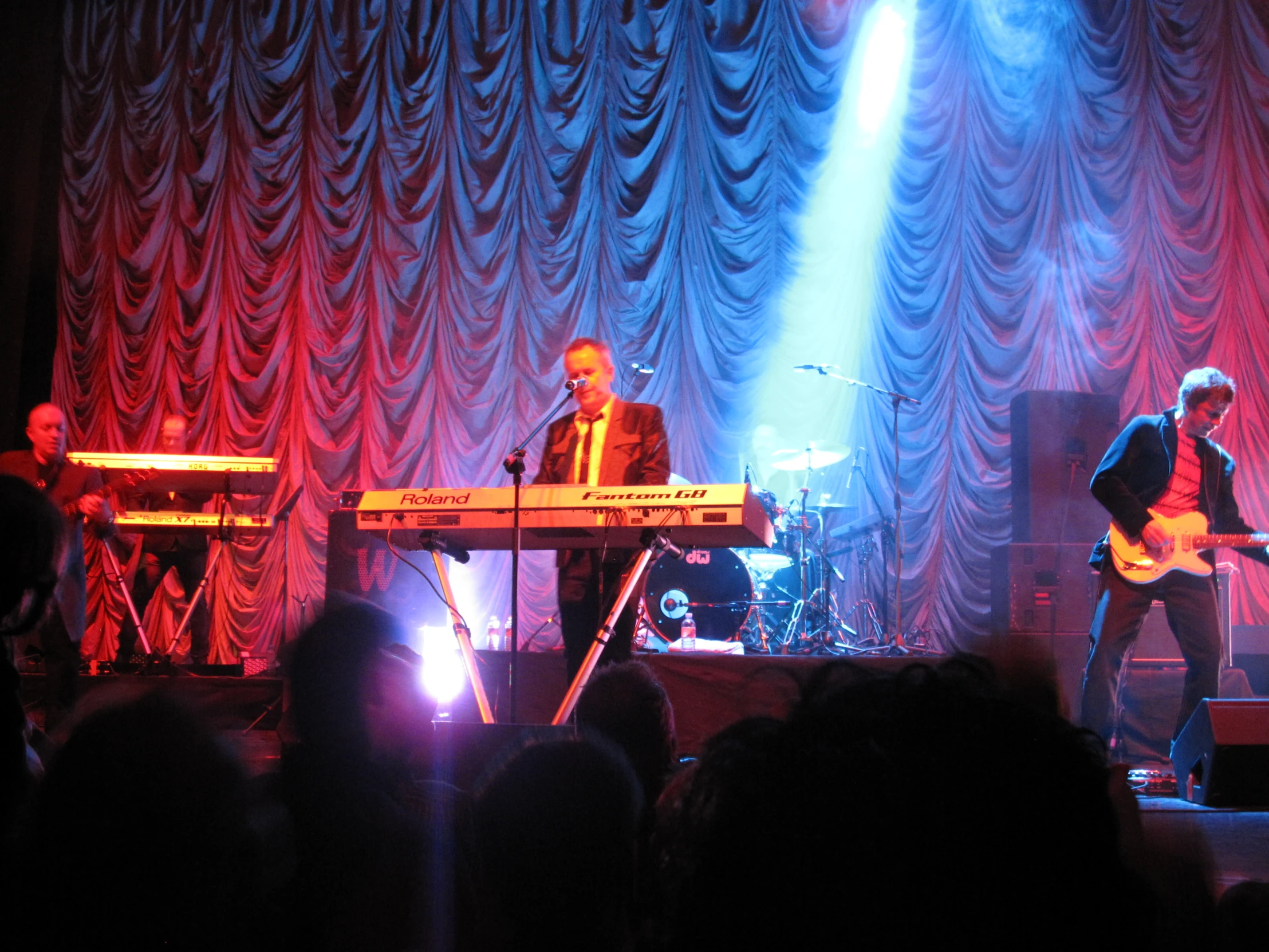 some people on stage playing music on a keyboard