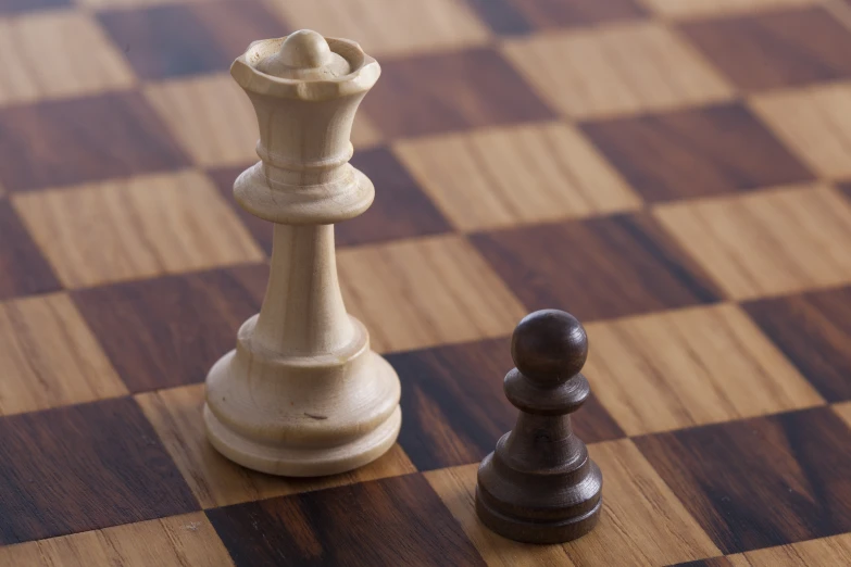 a close up of two wooden chess pieces