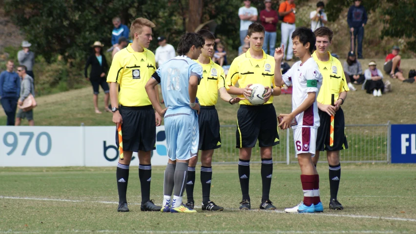 boys in soccer uniforms talking and holding soccer balls