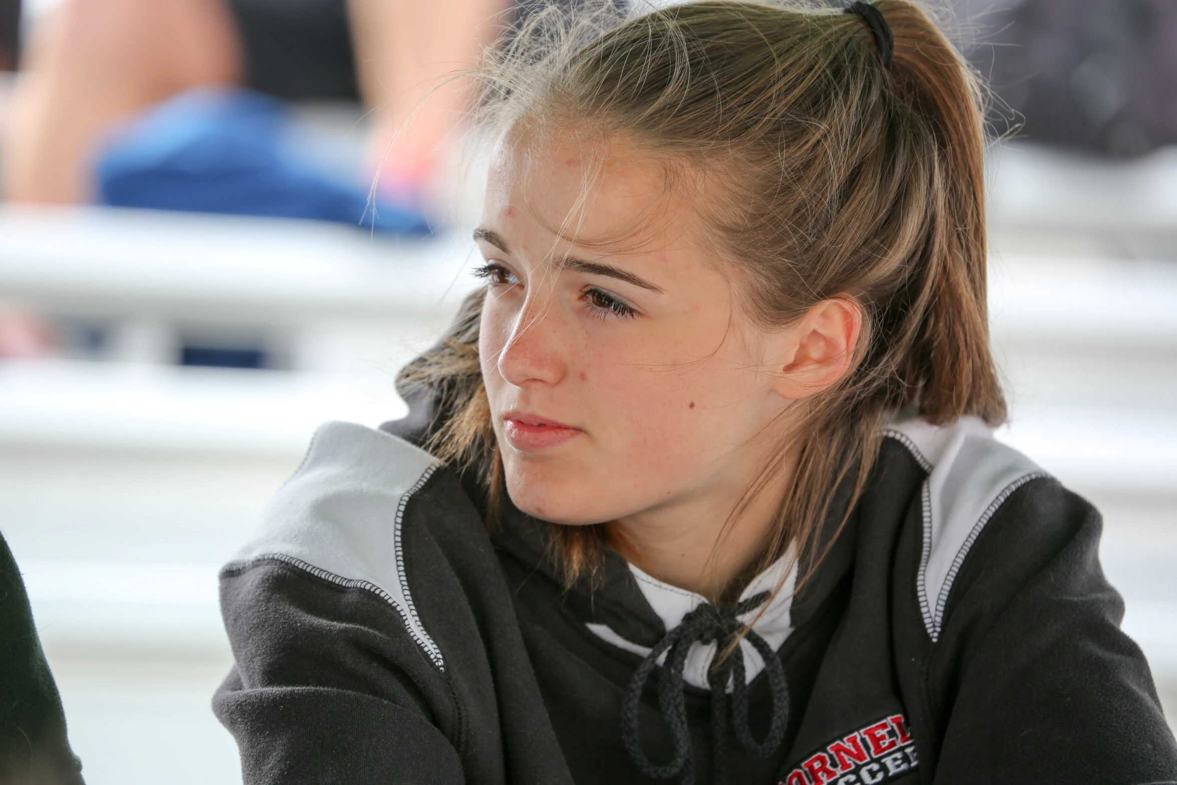 a female hockey player sitting at a bench