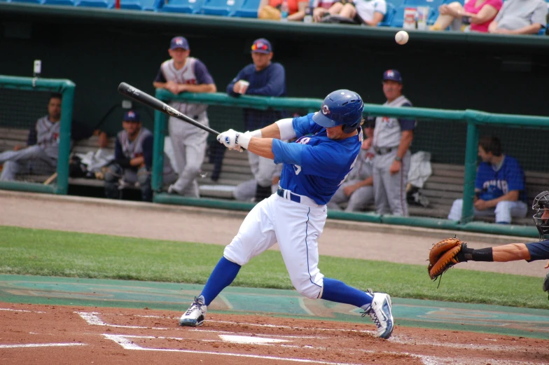 baseball batter swinging at pitch during game with audience watching