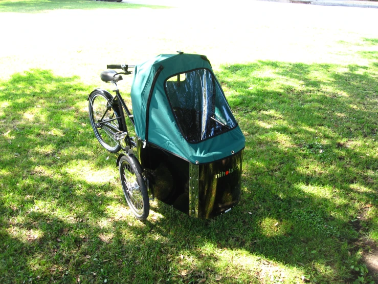 a bike is parked in a small cart attached to the back of a car