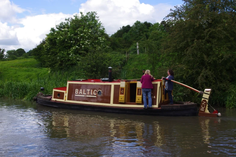 the two people are standing on the boat