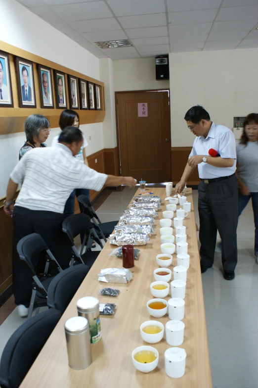 a buffet line of people preparing a meal for people to eat