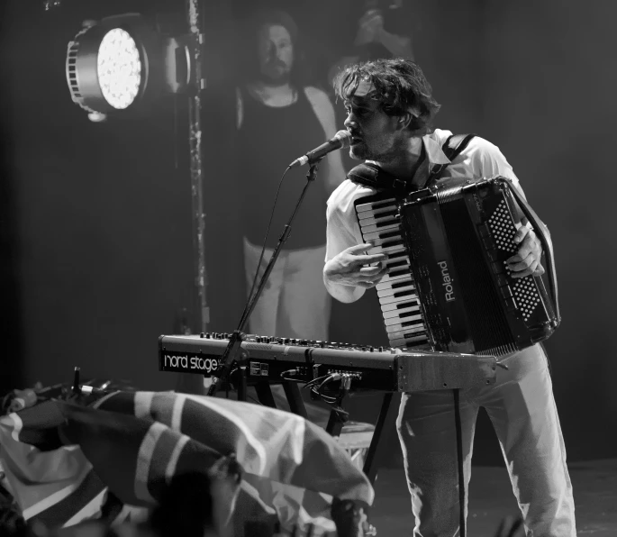 a man plays a musical instrument on stage