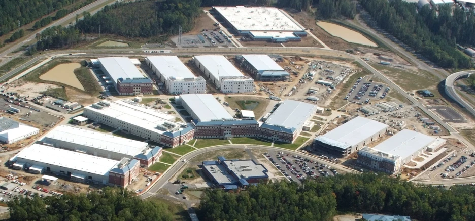 a large industrial complex next to trees and other machinery