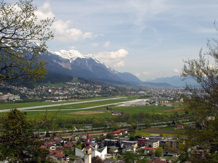 a town with a snowy mountain in the background