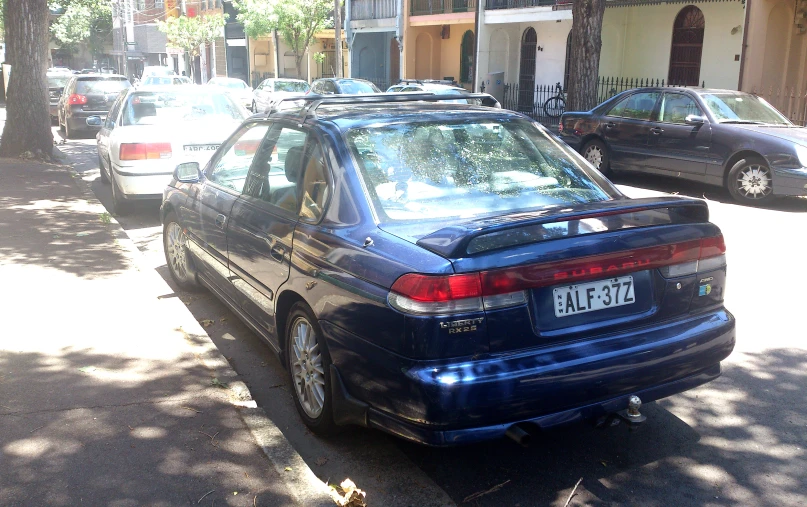 some cars are parked on a street with a sign that reads