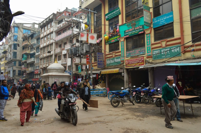 a bunch of people in the street next to some buildings