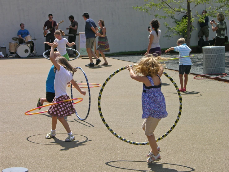 a group of young children holding hula hoops