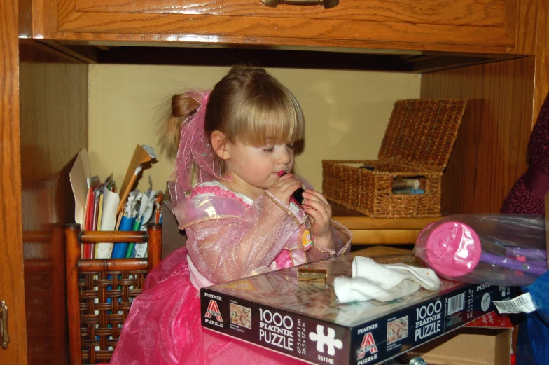 a child plays inside a cluttered doll closet