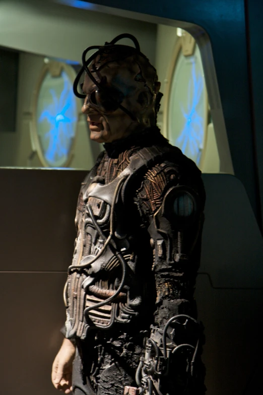 a man in a futuristic space suit standing with his hands behind him