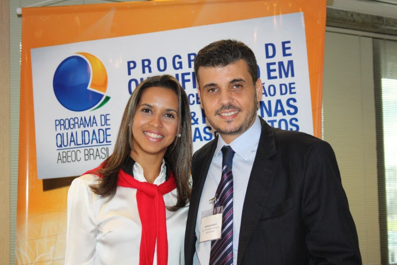 a couple poses for a picture at a conference