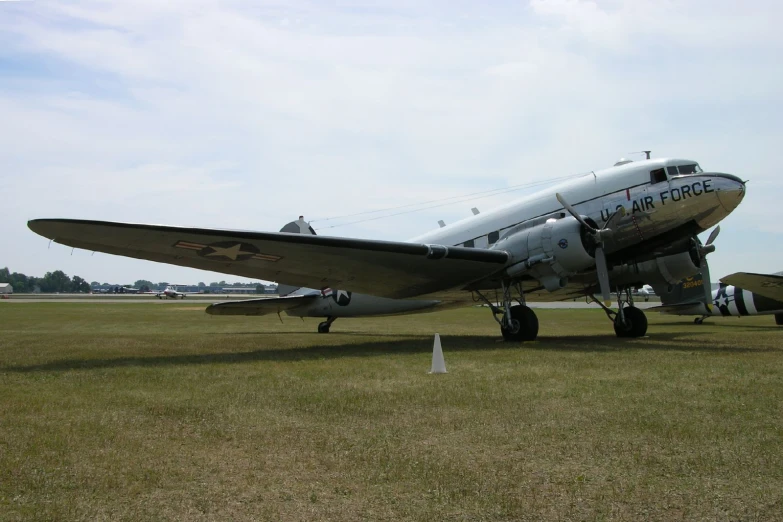 an old airplane sits on the runway at an airport