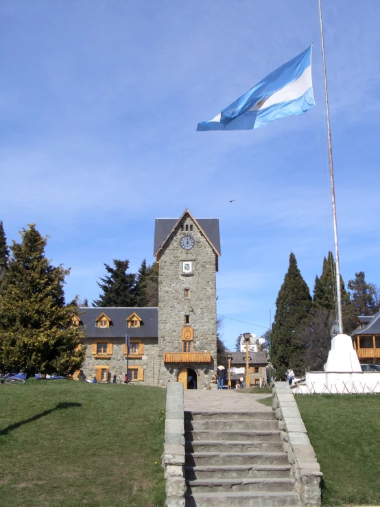 a flag is being lowered in front of a stone building