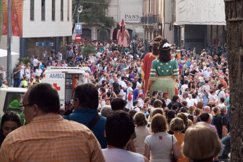 a crowd is walking in front of some buildings