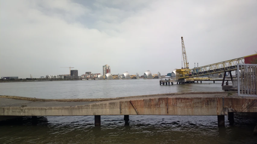 a pier with a crane on it is sitting in the water