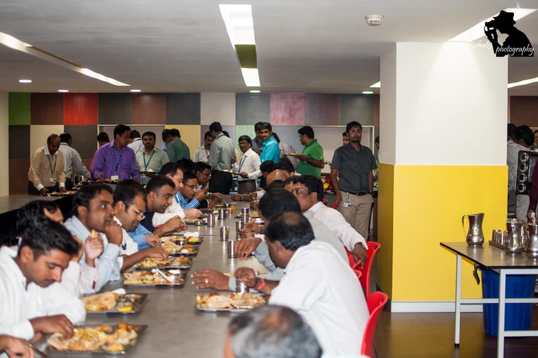 many men and women enjoy lunch together in the dining room