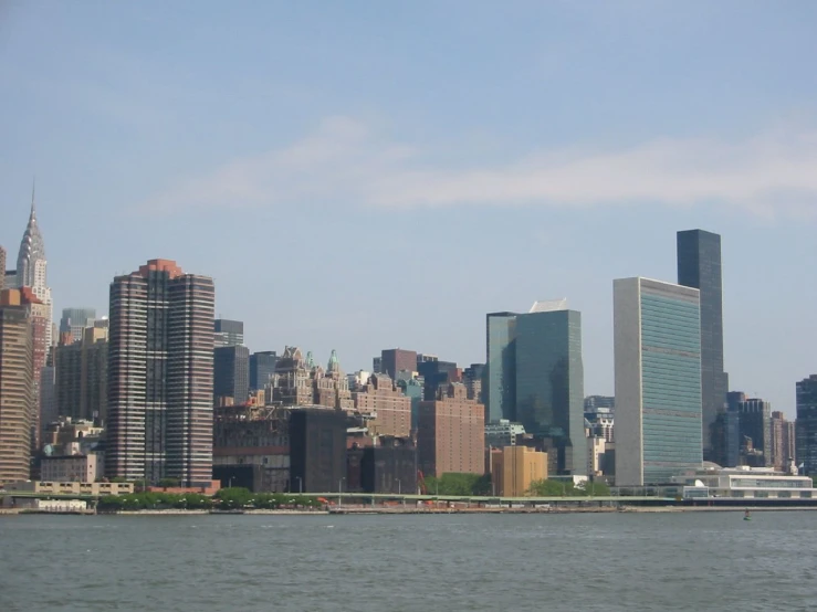 a view of the manhattan skyline, as seen from a boat on a river