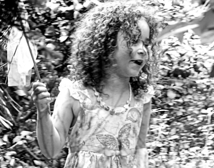 a black and white po of a child holding an umbrella