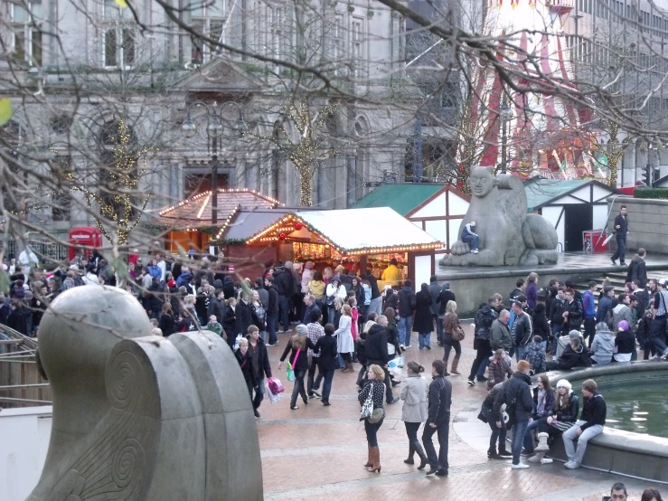 a group of people walking around in a plaza