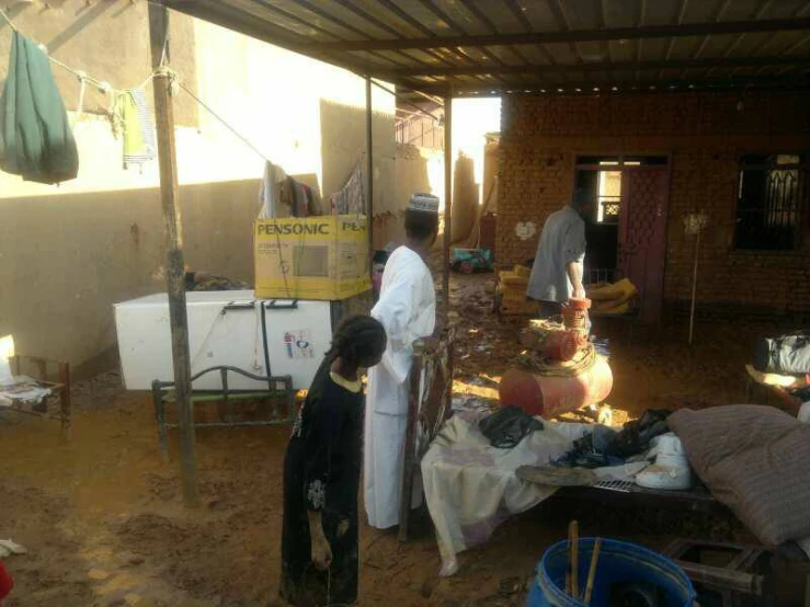 people in an open area near tables with bags