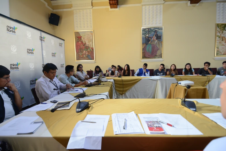 several people sitting at desks looking around