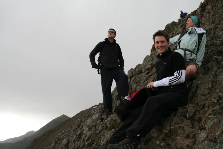 two men on top of rock hill in the desert