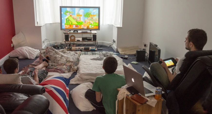 group of children on bean bag chairs playing a video game