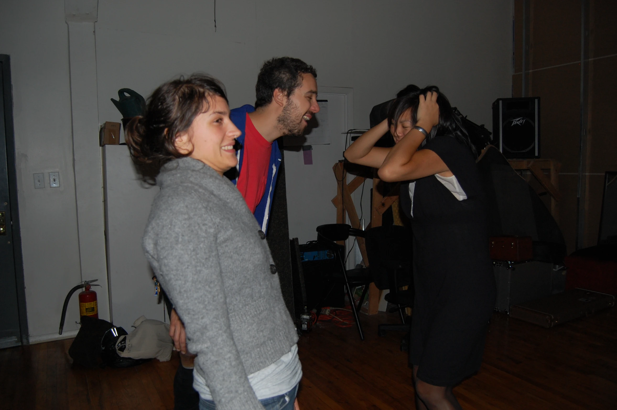 three people are dancing around together on a wooden floor