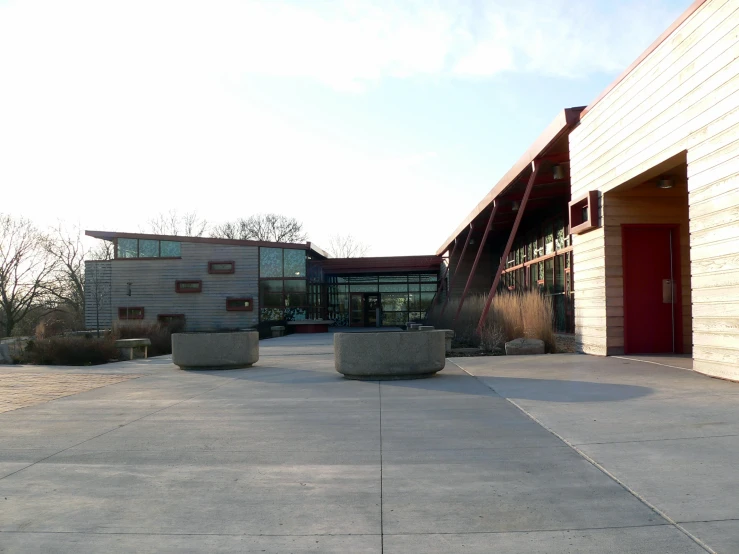 an empty courtyard with small round stone urns