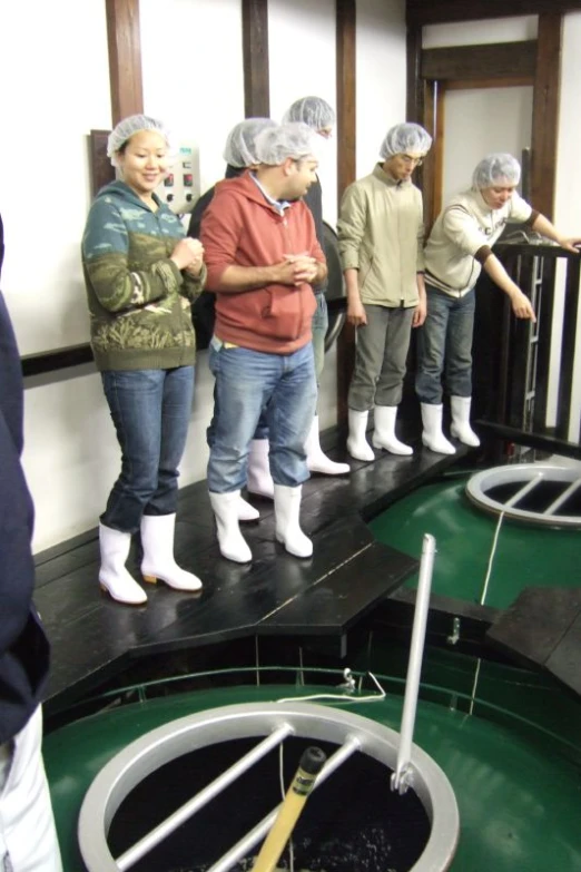 group of people playing mini golf in small office