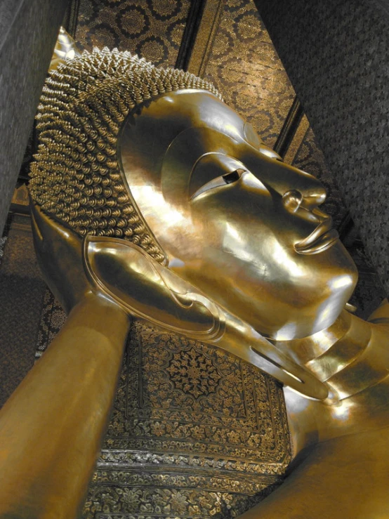 an ornate ss finish buddha statue with golden finish