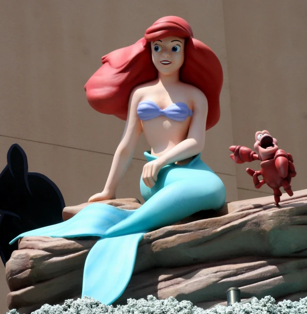 a woman sits on top of a rock while posing