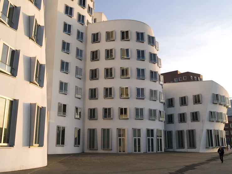 a white building with many windows near by