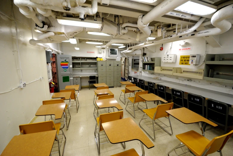 a very long row of desks near a wall