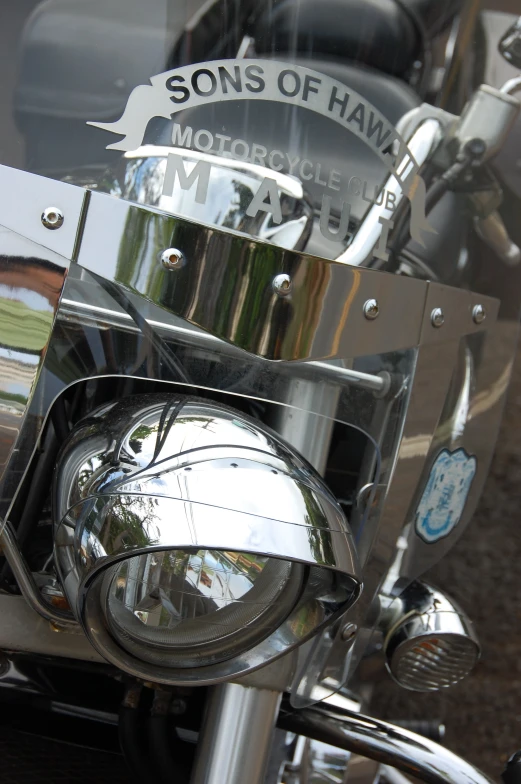 chrome handle bar on a motorcycle parked on the pavement