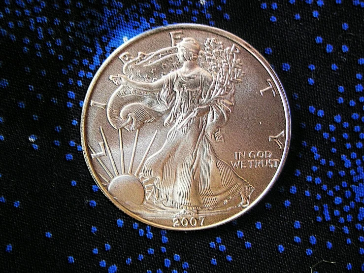 a coin sitting on top of a black table